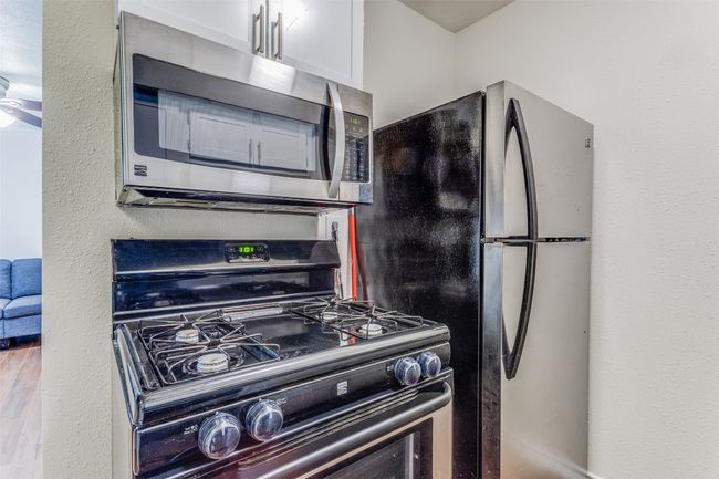 Kitchen featuring appliances with stainless steel finishes and a ceiling fan | Image 6