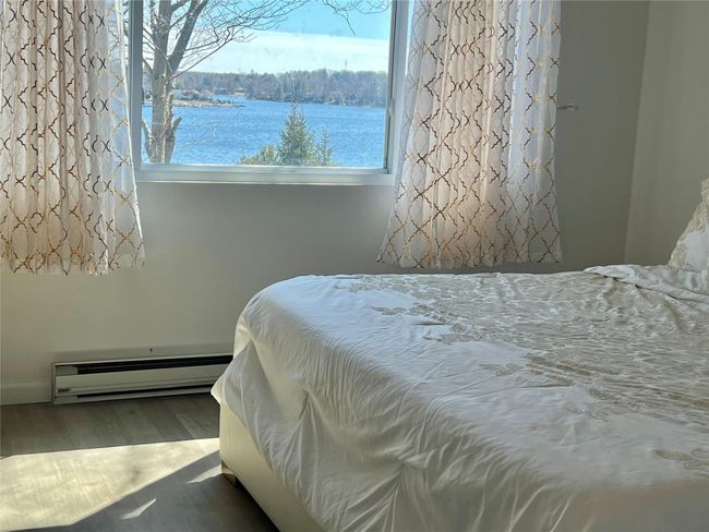 Bedroom with a baseboard radiator and wood finished floors | Image 46