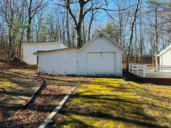 Garage featuring a yard | Image 18