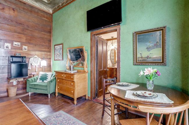 Keaton's Lodge features orginal hardwood floors, vintage repurposed tin stamped 10 foot ceilings | Image 26