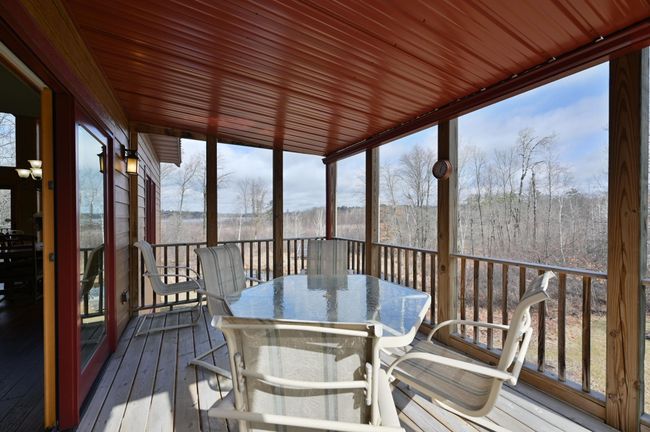 The screened-in deck is excellent for outdoor dining or games. | Image 27