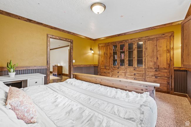 Carpeted bedroom with crown molding | Image 31