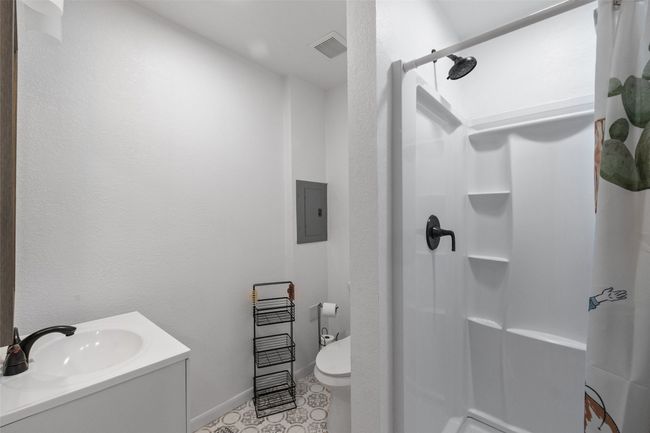 Full bathroom featuring vanity, baseboards, a stall shower, electric panel, and visible vents | Image 33