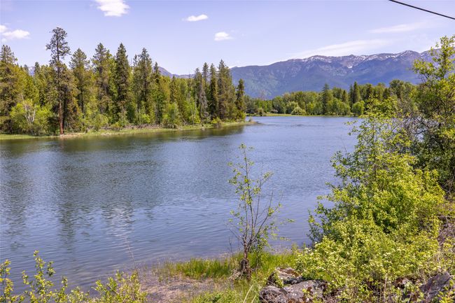 Water view featuring a forest and mountains | Image 110