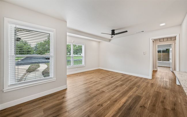 Empty room featuring wood finished floors and ceiling fan | Image 5