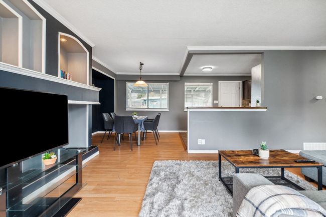 Living area featuring ornamental molding, baseboards, and light wood-style floors | Image 5