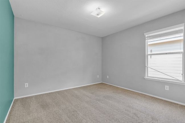 Bedroom with carpet. | Image 21