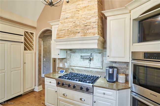 Kitchen with granite counters, vaulted ceiling, stainless steel appliances, and tasteful backsplash | Image 8