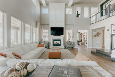 A striking two story fireplace with custom millwork bridges the warm interior to the open air serenity beyond and anchors the great room with its commanding presence. | Image 3