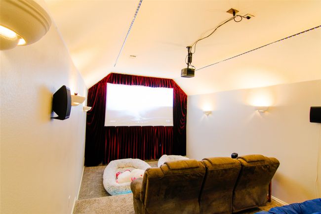 Carpeted cinema room with vaulted ceiling and baseboards | Image 20