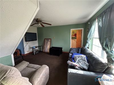 Family Room extending underneath the stairs. | Image 3