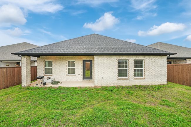 Back of property with a yard, a fenced backyard, a patio area, and roof with shingles | Image 30