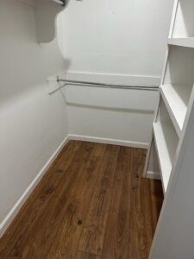 Spacious closet featuring wood finished floors | Image 18