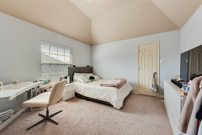 Bedroom with light carpet and high vaulted ceiling | Image 24