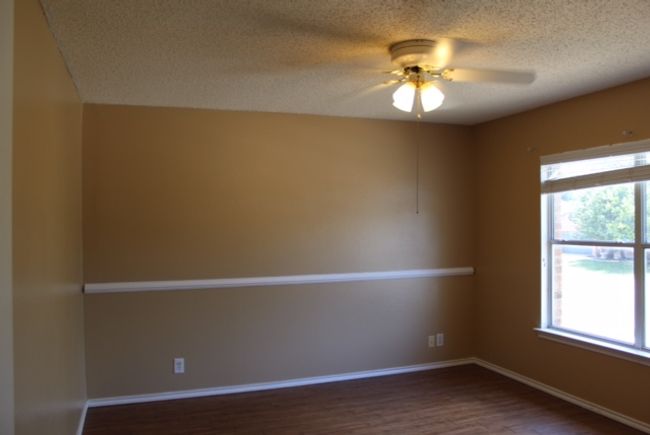 Spare room with dark wood finished floors, a textured ceiling, a ceiling fan, and baseboards | Image 11