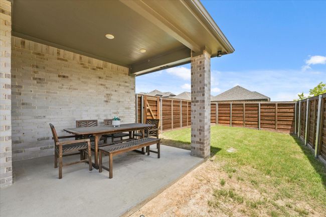 Fenced backyard featuring outdoor dining space and a patio | Image 34