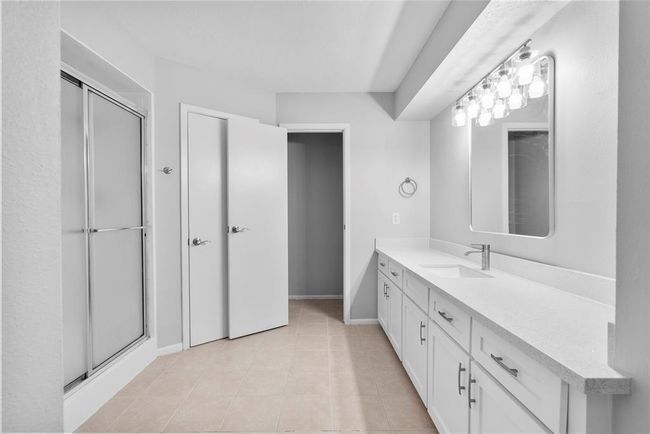 The primary bath has generous storage space & counterspace to make getting ready a breeze! | Image 17
