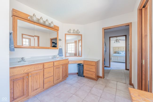 bathroom featuring double vanity, connected bathroom, tile patterned floors, and a sink | Image 23