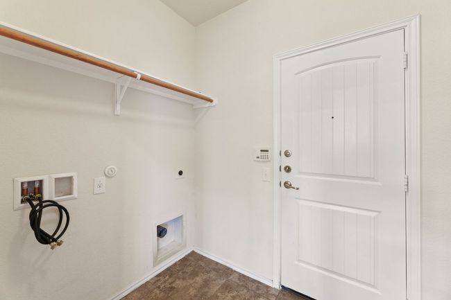 Laundry room with hookup for an electric dryer, hookup for a washing machine, and gas dryer hookup | Image 9