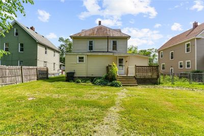 Rear view of house with a lawn and a deck | Image 2