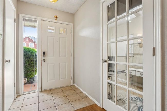 Front Entry with tile flooring a window for sunlight and security | Image 5
