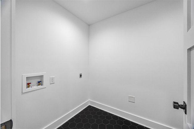 Washroom featuring baseboards, hookup for an electric dryer, washer hookup, and laundry area | Image 38
