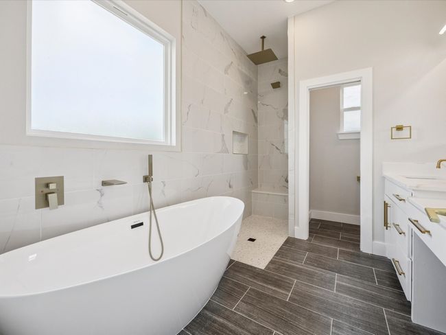 Full bath with a freestanding tub, vanity, and walk in shower | Image 17