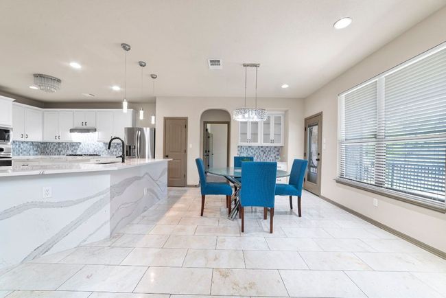 Dining room with recessed lighting, arched walkways, and light tile patterned floors | Image 14