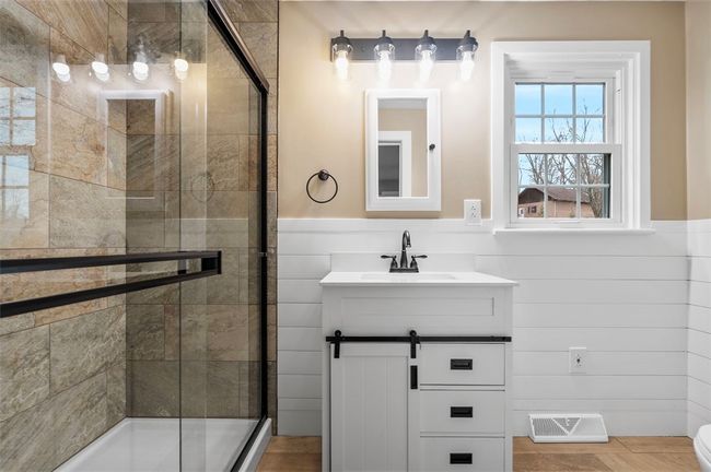 Newly updated Primary bathroom. Ceramic tiled shower with glass door enclosure. | Image 10