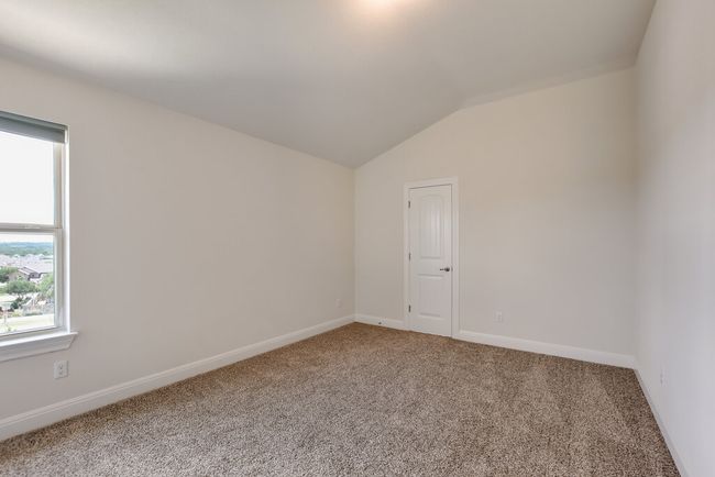 Carpeted spare room featuring vaulted ceiling and baseboards | Image 30