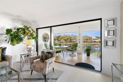 Doorway to outside featuring a water view and wood-type flooring | Image 3