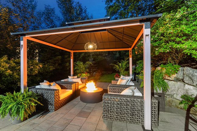 View of patio featuring a gazebo and an outdoor living space with a fire pit | Image 20