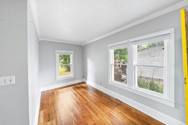Spare room featuring ornamental molding, baseboards, and hardwood / wood-style floors | Image 12
