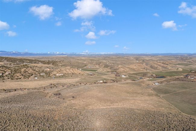 Aerial view of sparsely populated area featuring a mountainous background | Image 19