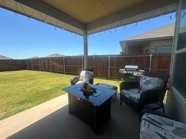 Fenced backyard featuring area for grilling and a patio area | Image 16