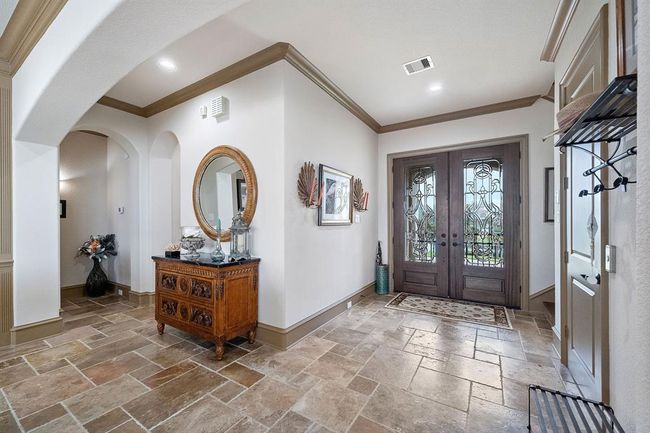 A welcoming travertine entrance with elevator to the right side of the photo. The elevator reaches all levels for convenience | Image 6