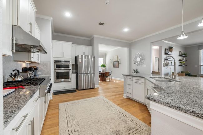 Cook and bake til your hgeart's content in this fully equipped kitchen complete with ample cabinetry, under cabinet kitchen lighting and pantry. | Image 16
