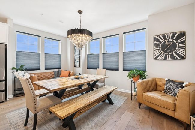 This photo shows the informal dining area that can easily be transformed into a formal dining space, highlighted by the elegant black chandelier for a sophisticated touch. | Image 21