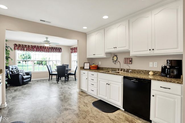 kitchen featuring dishwasher, a sink, dark stone countertops, recessed lighting, and baseboards | Image 13