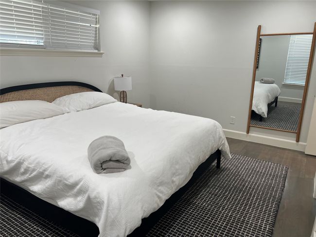 Beautiful primary bedroom with laminate wood floors | Image 10