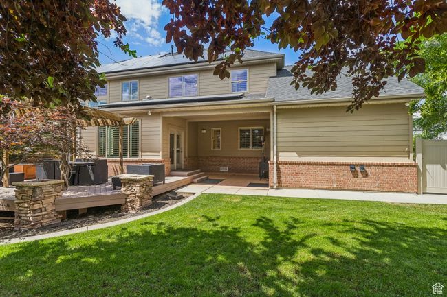 Back of property with a patio area and solar panels | Image 73