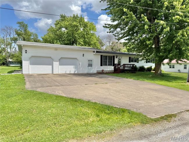 Ranch-style home with a garage, concrete driveway, and a front lawn | Image 4