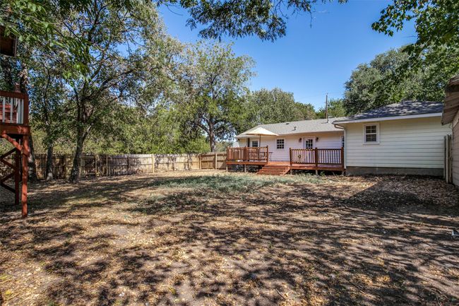 Fenced backyard with a wooden​​‌​​​​‌​​‌‌​‌‌​​​‌‌​​‌‌​‌​​​​​‌ deck | Image 24