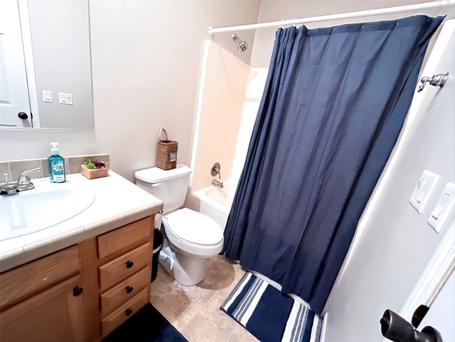 Full bathroom with toilet, vanity, and shower / tub combo with curtain | Image 28