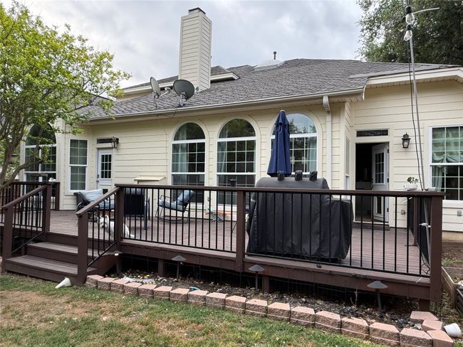 Back of property with a chimney, roof with shingles, and a deck | Image 37