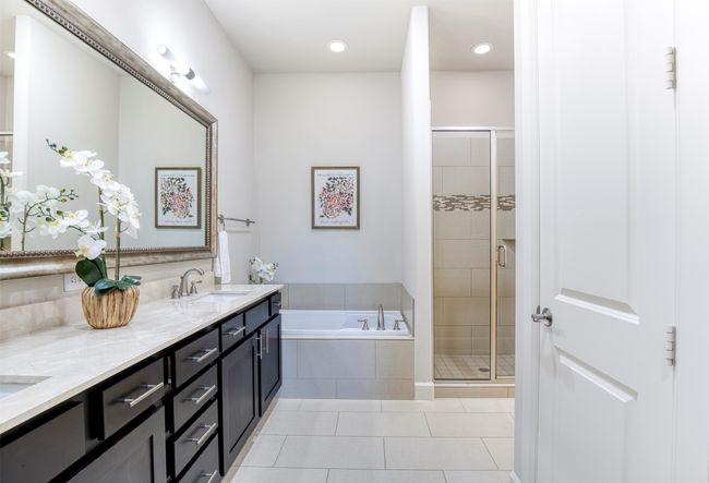 En-suite bath with linen closet, soaking tub, and separate shower. | Image 18