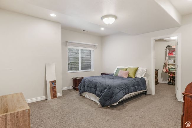 Bedroom with a spacious closet, recessed lighting, baseboards, and carpet floors | Image 20