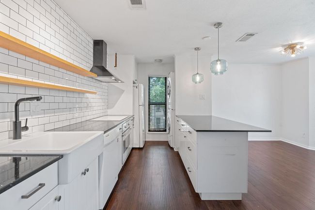 The farmhouse sink and floating upper shelving add to the contemporary allure. | Image 5