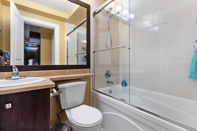 Bathroom featuring toilet, vanity, and enclosed tub / shower combo | Image 31