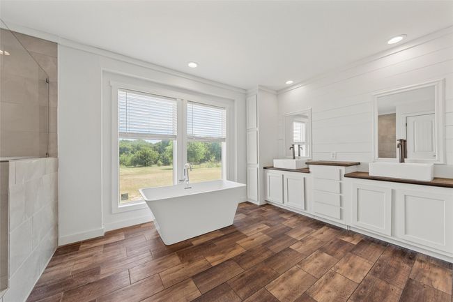 Full bathroom with a freestanding tub, a tile shower, dark wood-style floors, and recessed lighting | Image 16